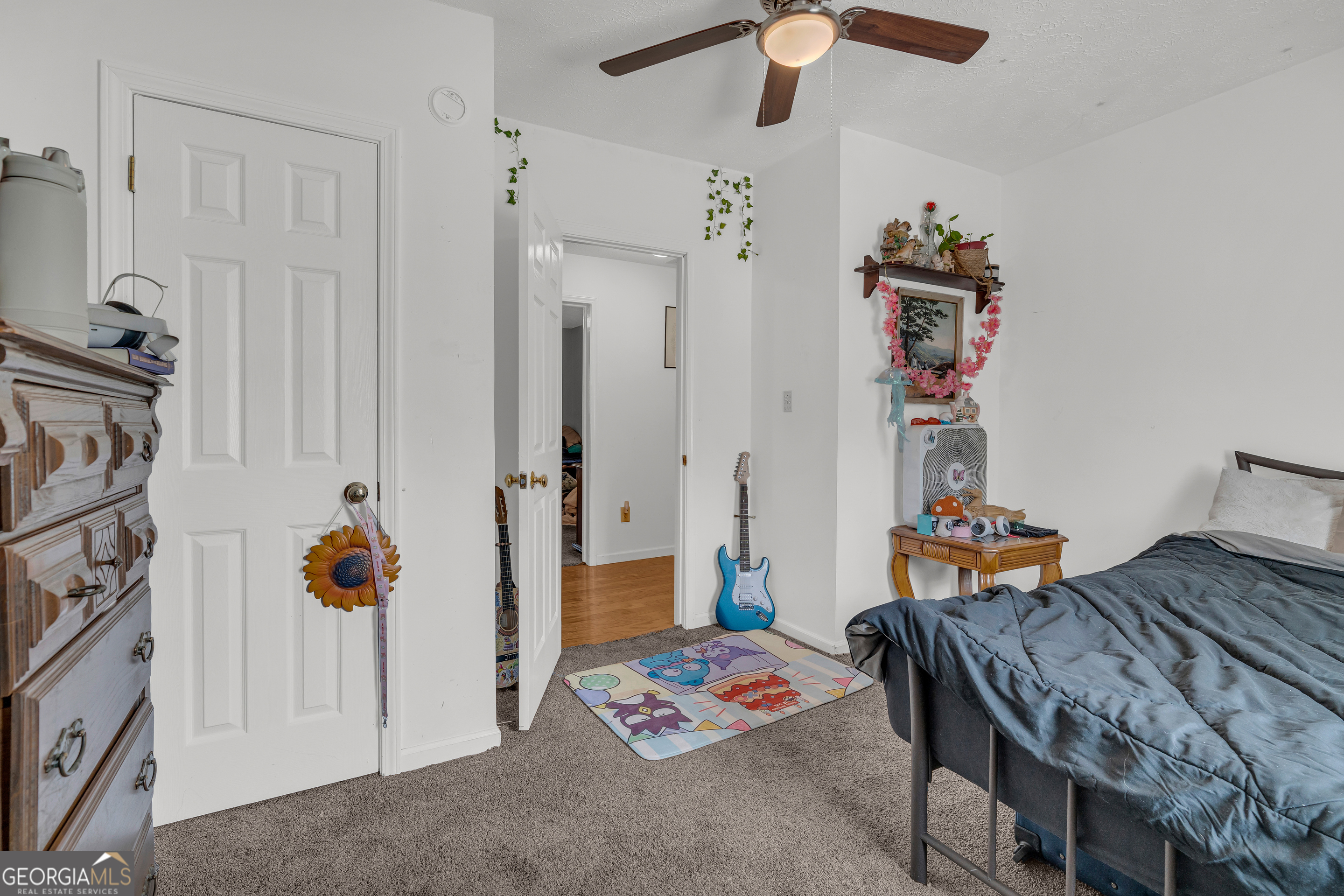 878 Jackson Street Locust Grove, GA 30248 - Photo 34 of 65 a bedroom with furniture and a chandelier