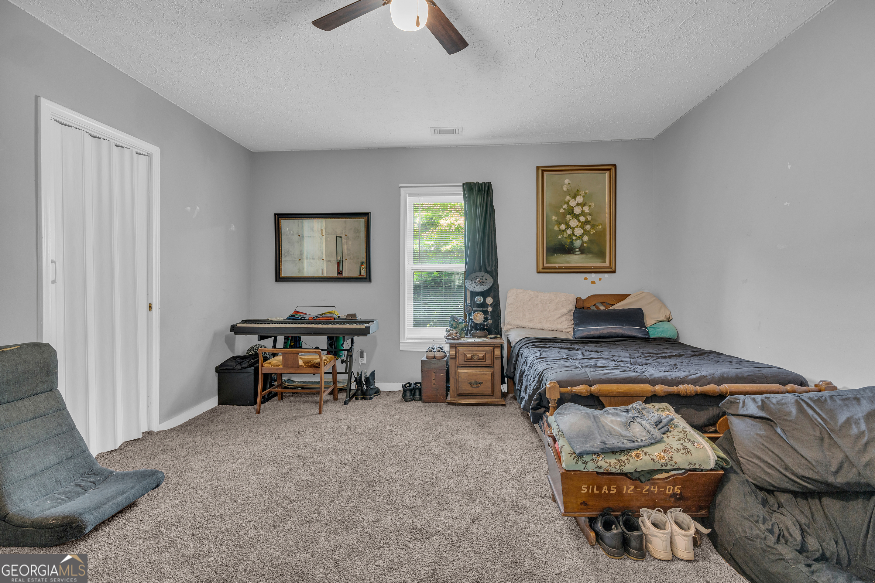 878 Jackson Street Locust Grove, GA 30248 - Photo 35 of 65 a bedroom with furniture and a window