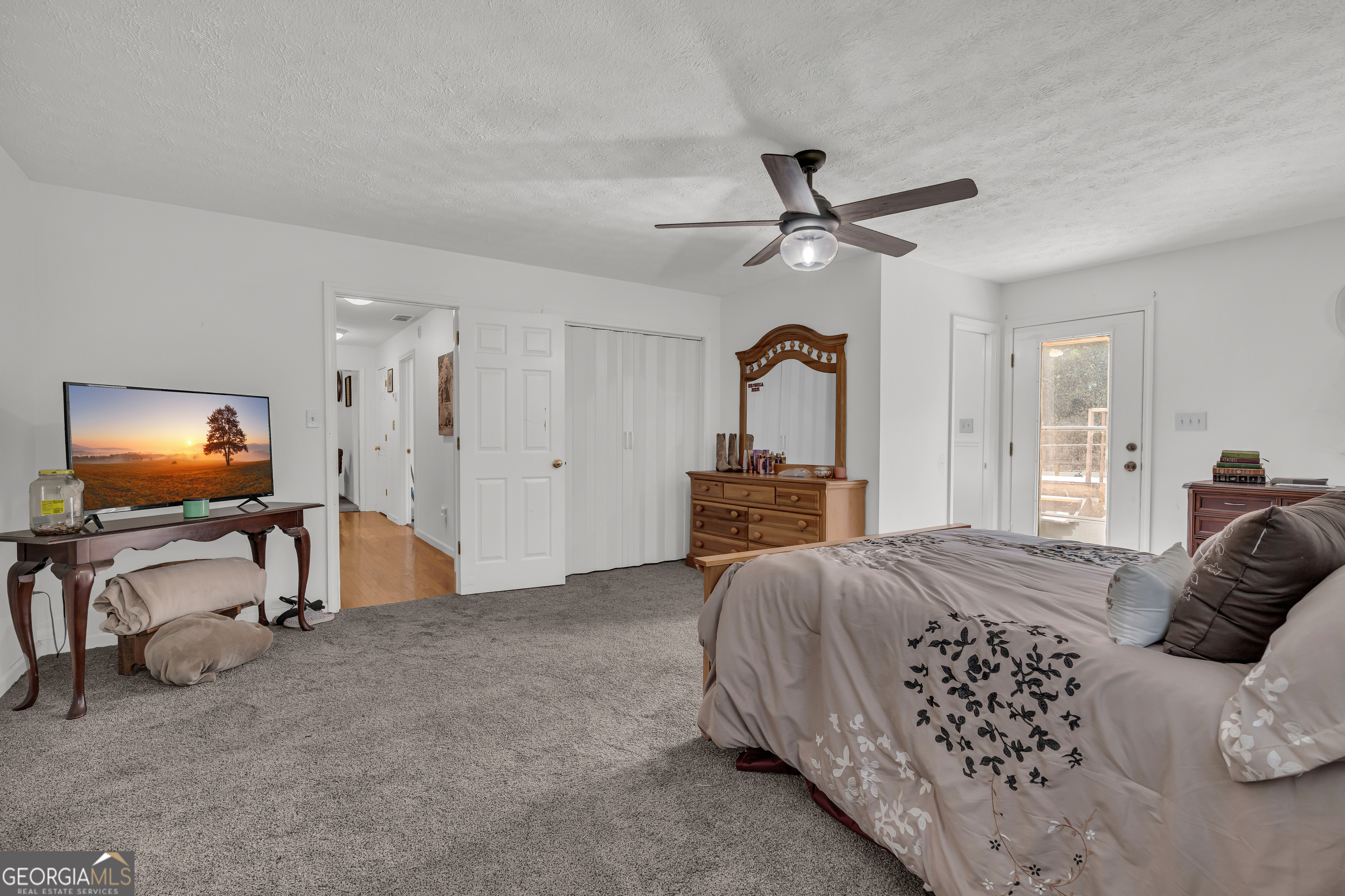 878 Jackson Street Locust Grove, GA 30248 - Photo 38 of 65 a bedroom with furniture and a flat screen tv