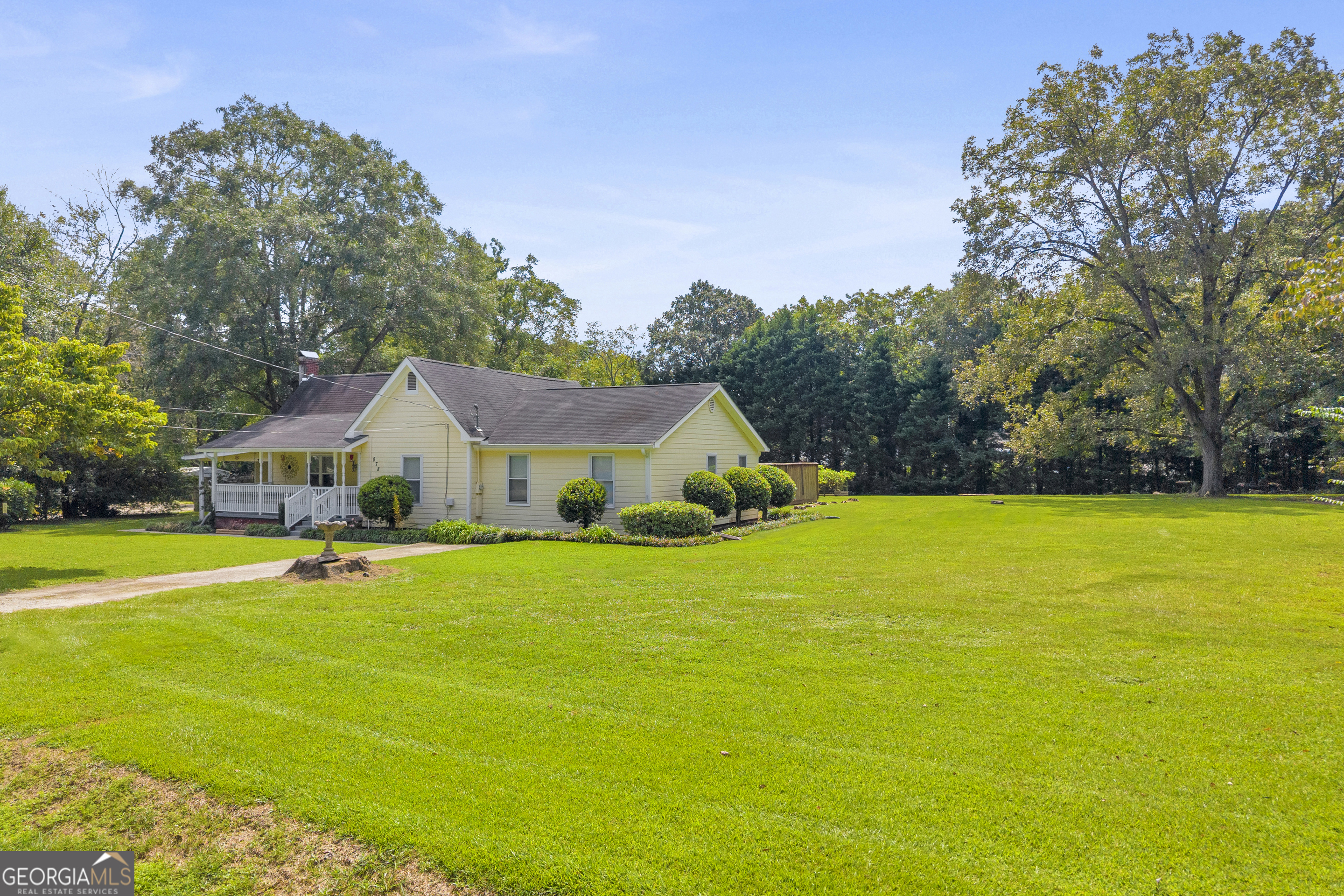 878 Jackson Street Locust Grove, GA 30248 - Photo 4 of 65 a front view of house with yard and trees in the background