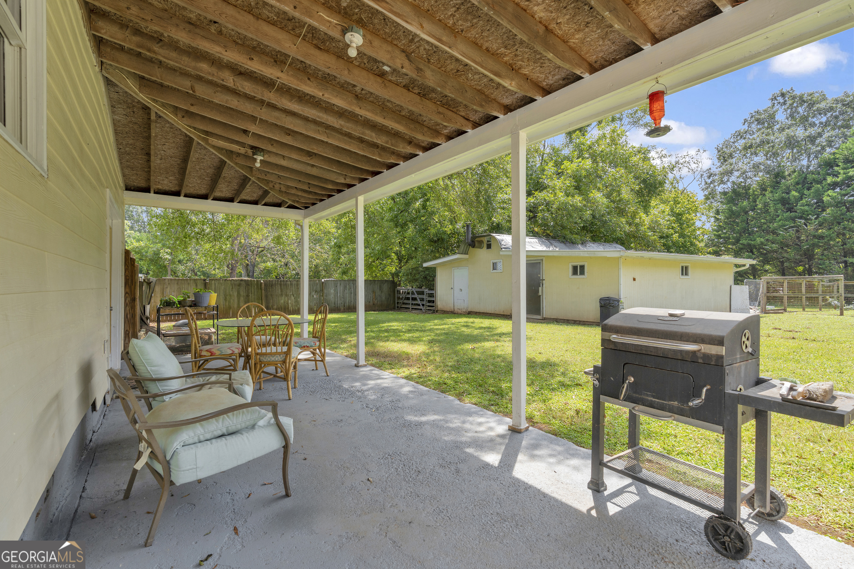 878 Jackson Street Locust Grove, GA 30248 - Photo 47 of 65 a view of a chairs and table in the patio