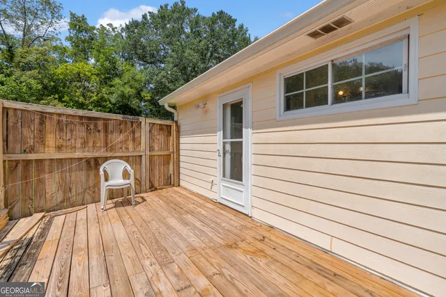 a view of a house with a yard deck and furniture