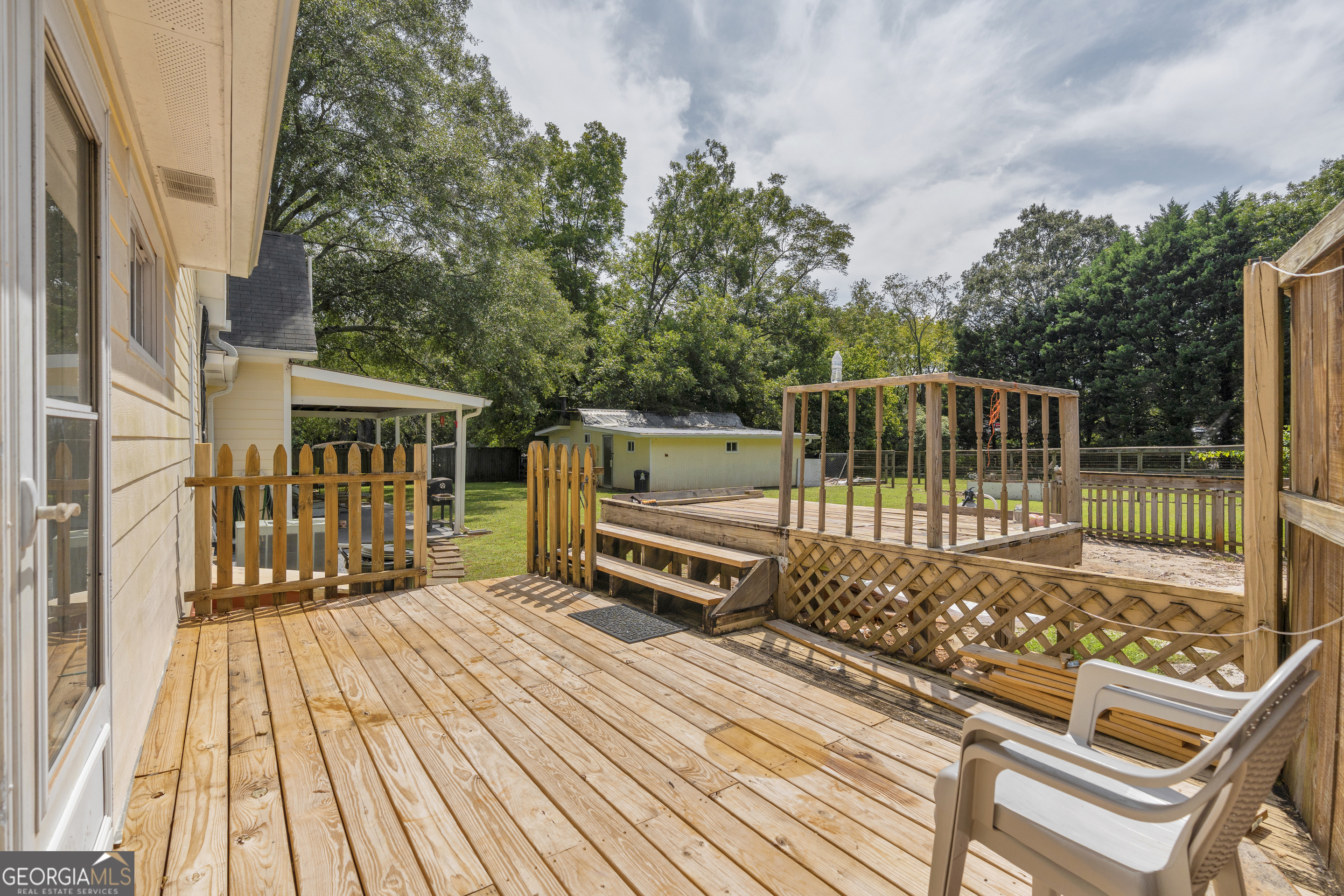 878 Jackson Street Locust Grove, GA 30248 - Photo 49 of 65 a view of a deck with wooden floor and fence