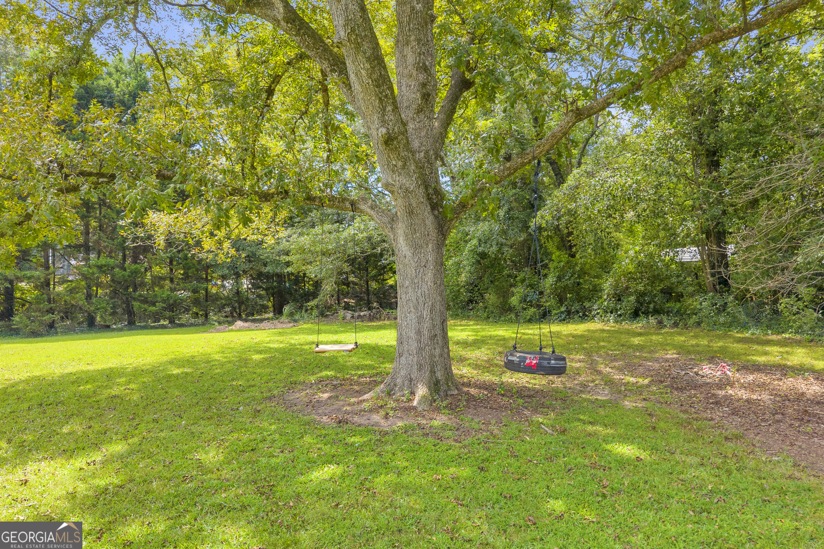 878 Jackson Street Locust Grove, GA 30248 - Photo 50 of 65 a view of a yard with a tree