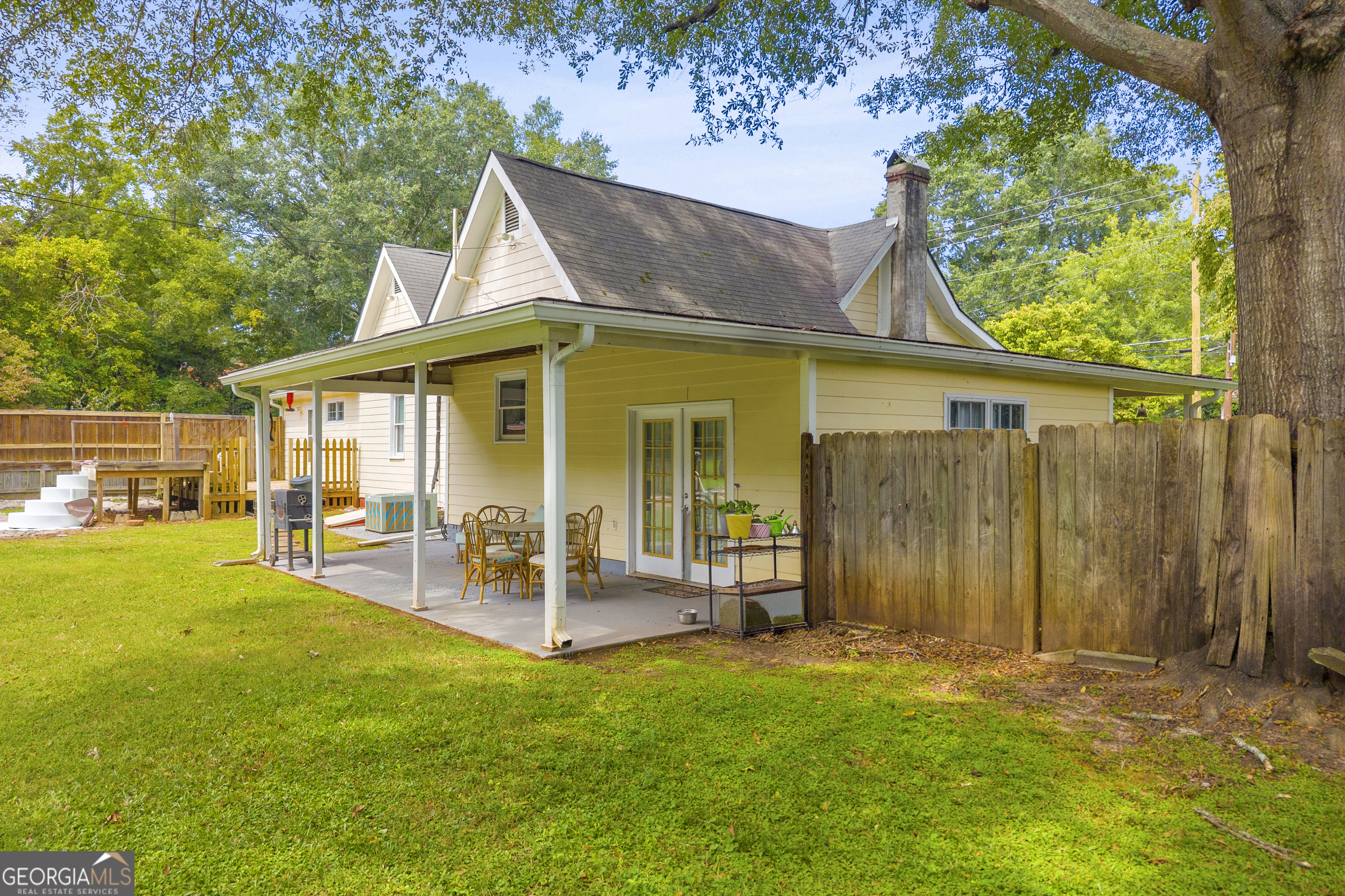 878 Jackson Street Locust Grove, GA 30248 - Photo 60 of 65 a view of a house with a yard patio and sitting area