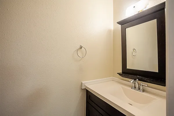 a bathroom with a toilet and a vanity