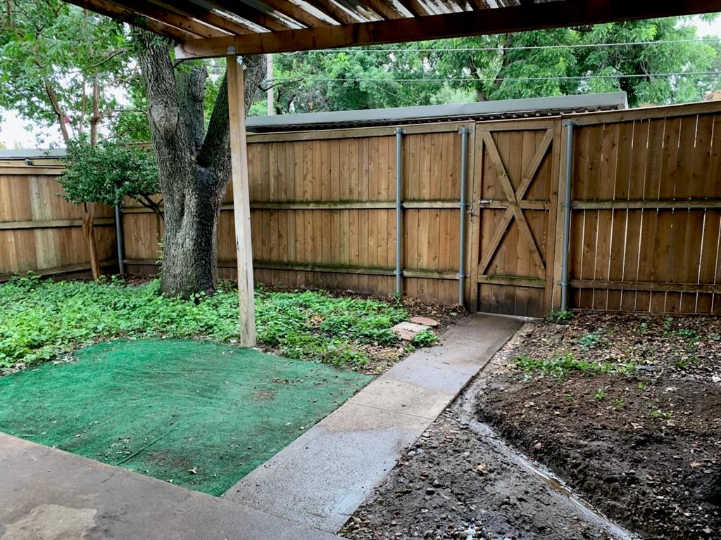 13652 Flagstone Lane Dallas, TX 75240 - Photo 15 of 15 Fenced yard with a gate and a pergola
