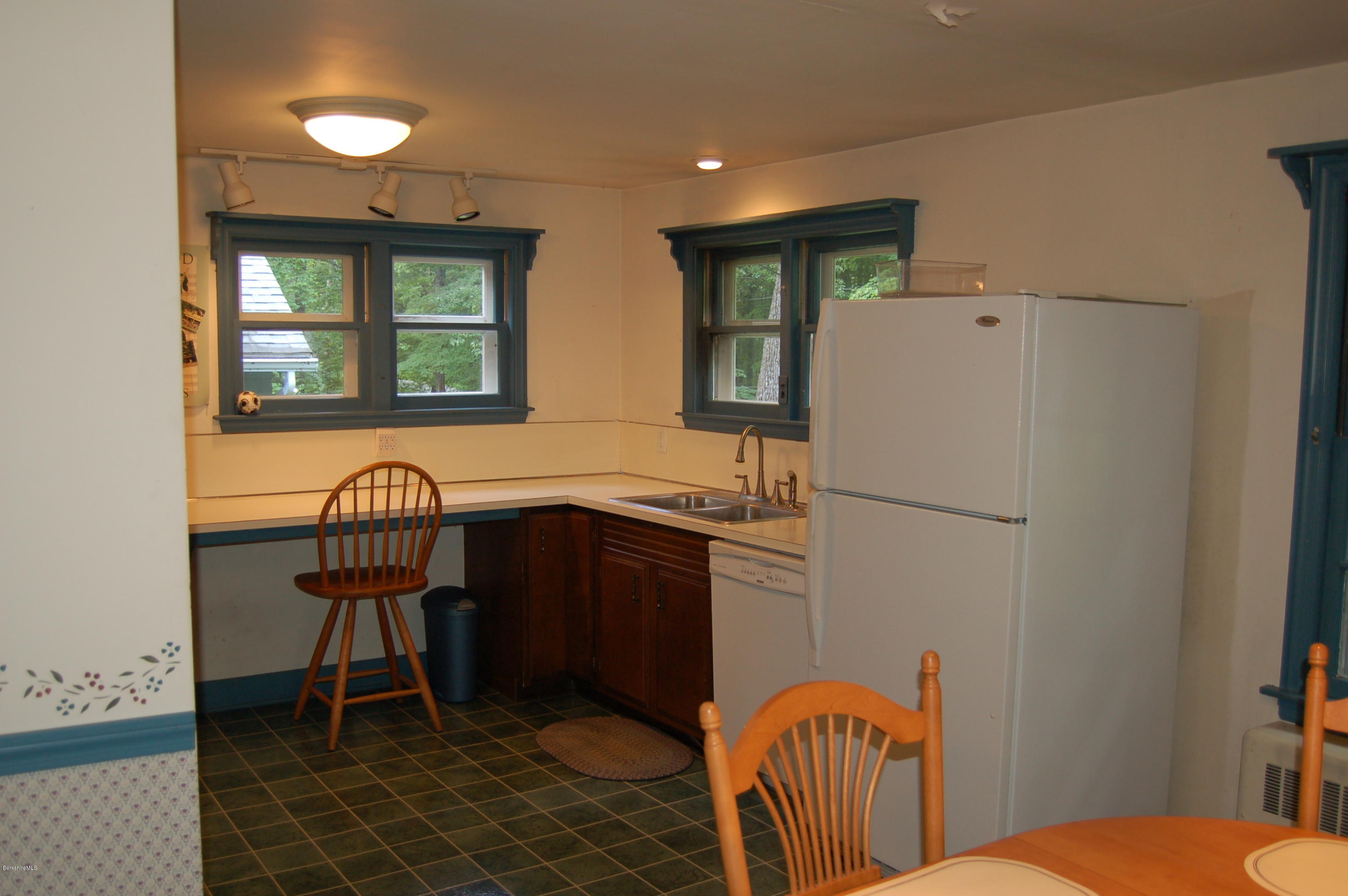 4 West Dale Road Stockbridge, MA 01229 - Photo 6 of 16 a kitchen with stainless steel appliances granite countertop a refrigerator a sink a stove and a dining table with wooden floor