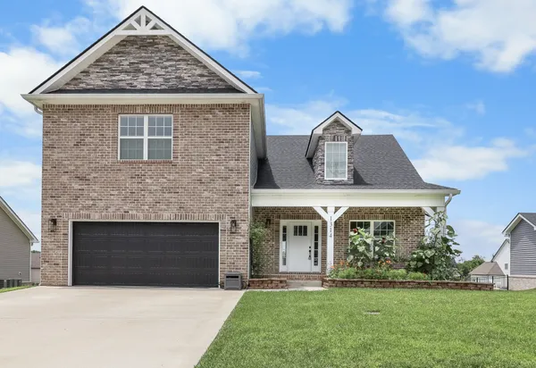 a front view of a house with a yard
