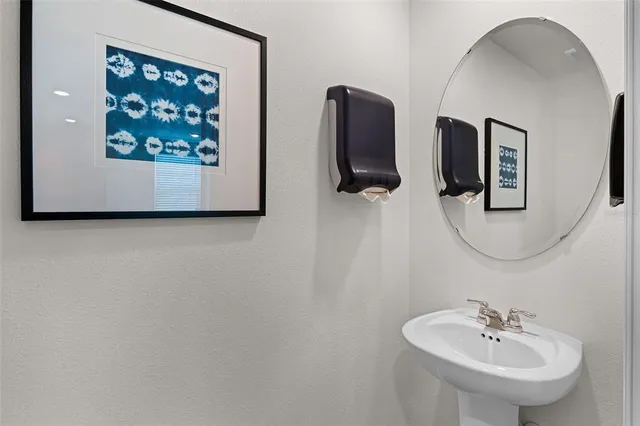 a bathroom with a sink and mirror