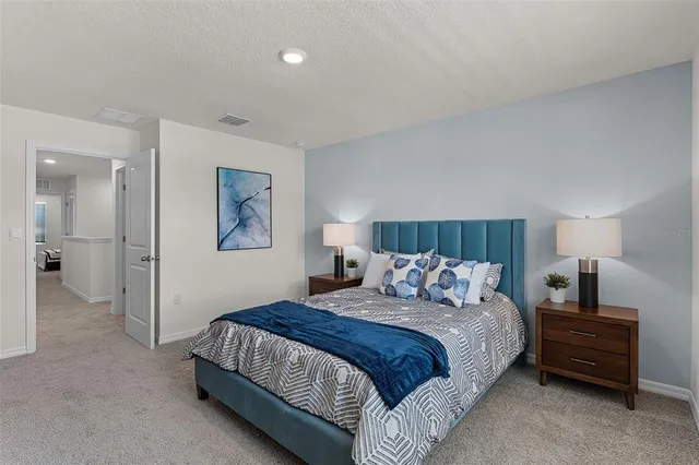 a bedroom with a bed and a lamp