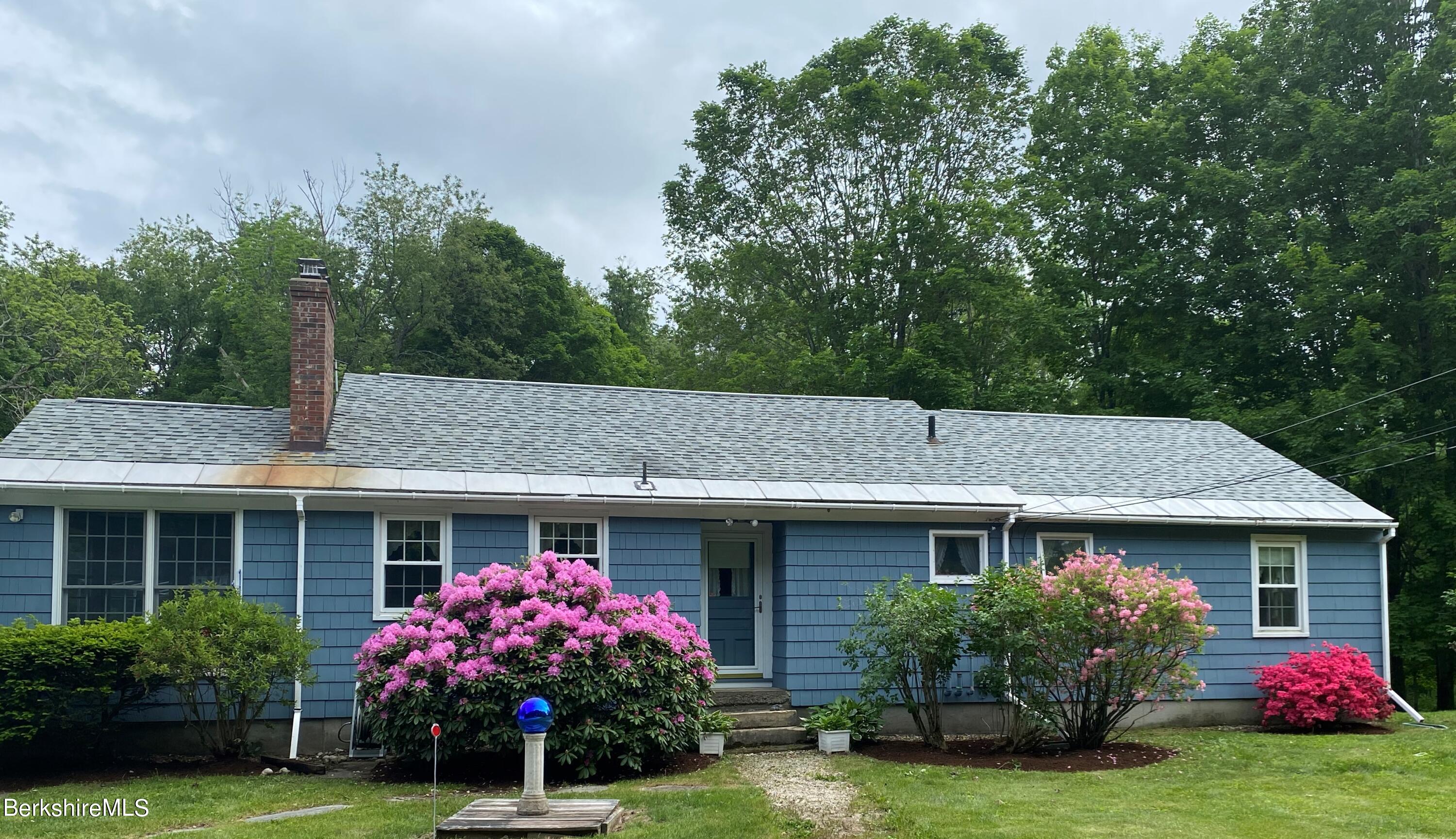 983 State Road Richmond, MA 01254 - Photo 2 of 47 a front view of a house with garden