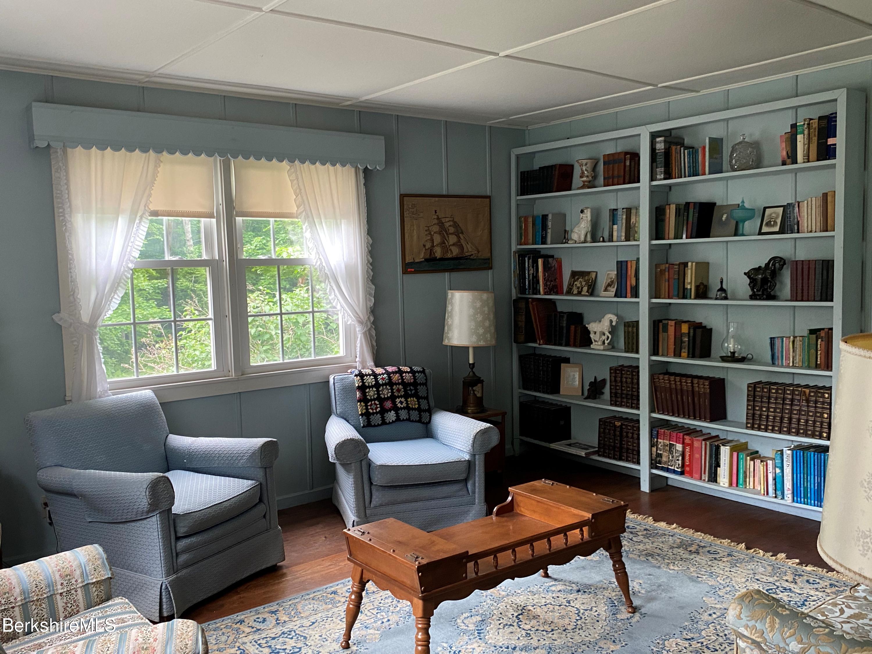 983 State Road Richmond, MA 01254 - Photo 17 of 47 a living room with furniture and a book shelf