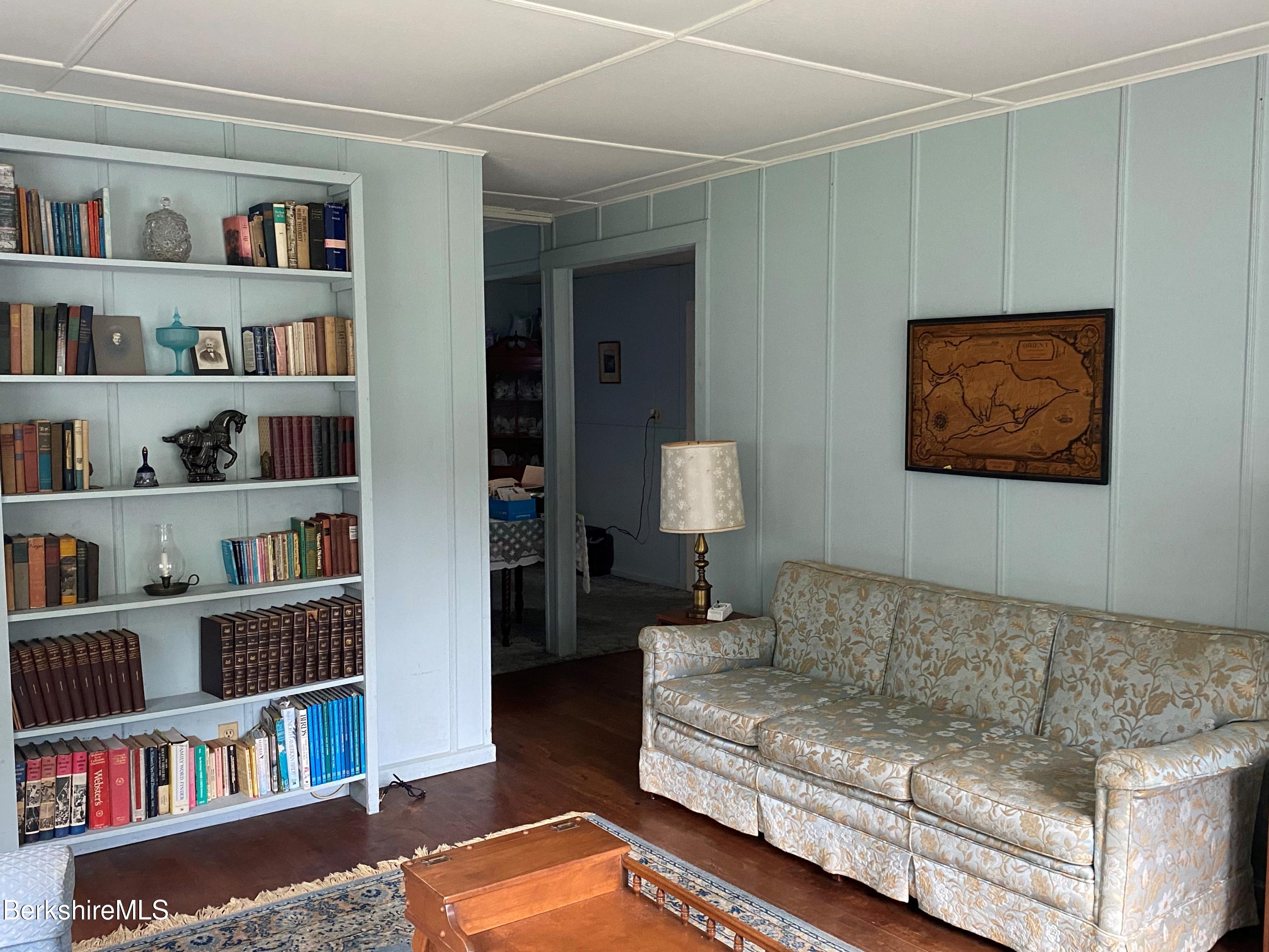 983 State Road Richmond, MA 01254 - Photo 19 of 47 a living room with furniture and a book shelf