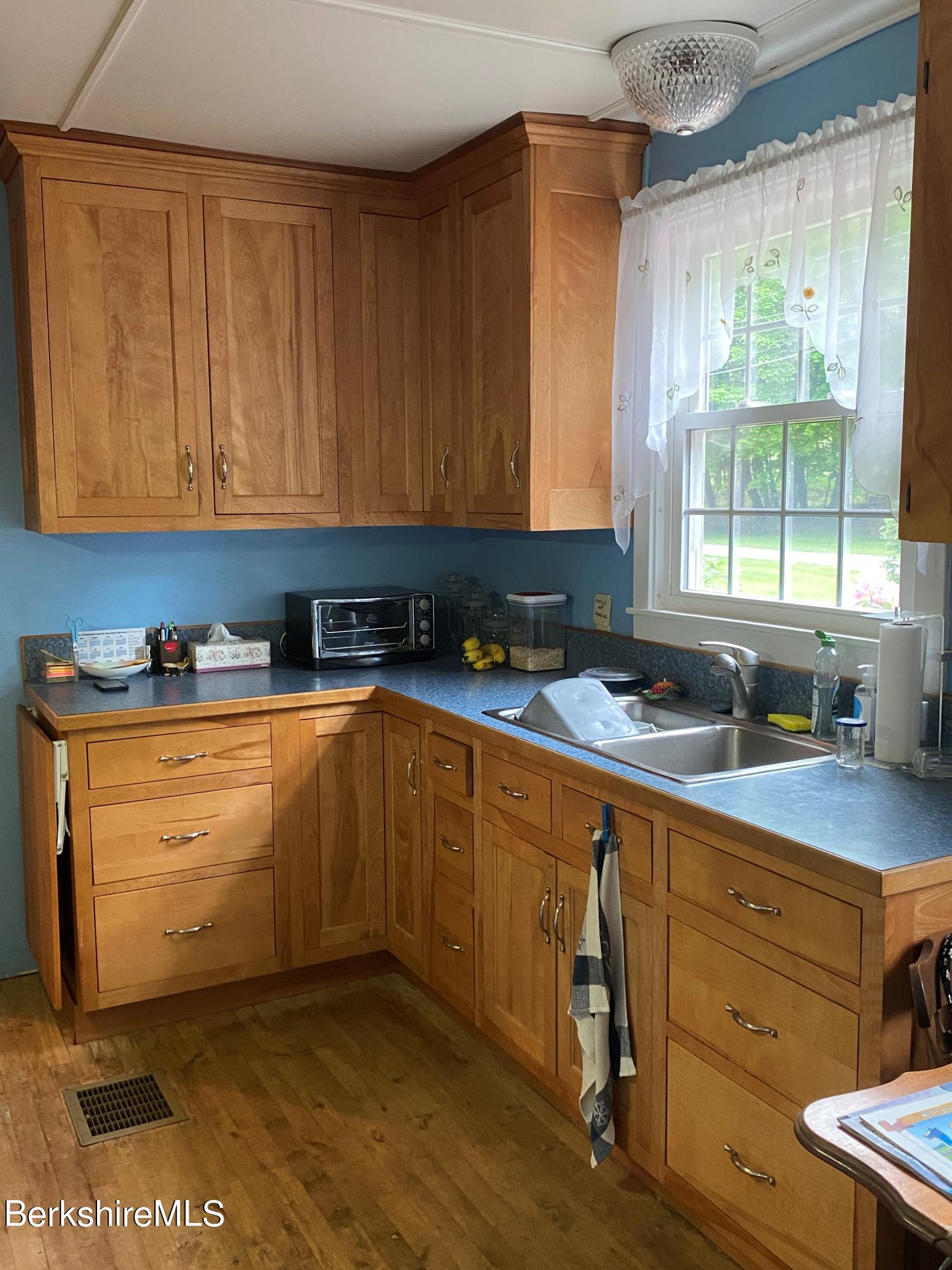 983 State Road Richmond, MA 01254 - Photo 22 of 47 a kitchen with granite countertop a sink window and cabinets