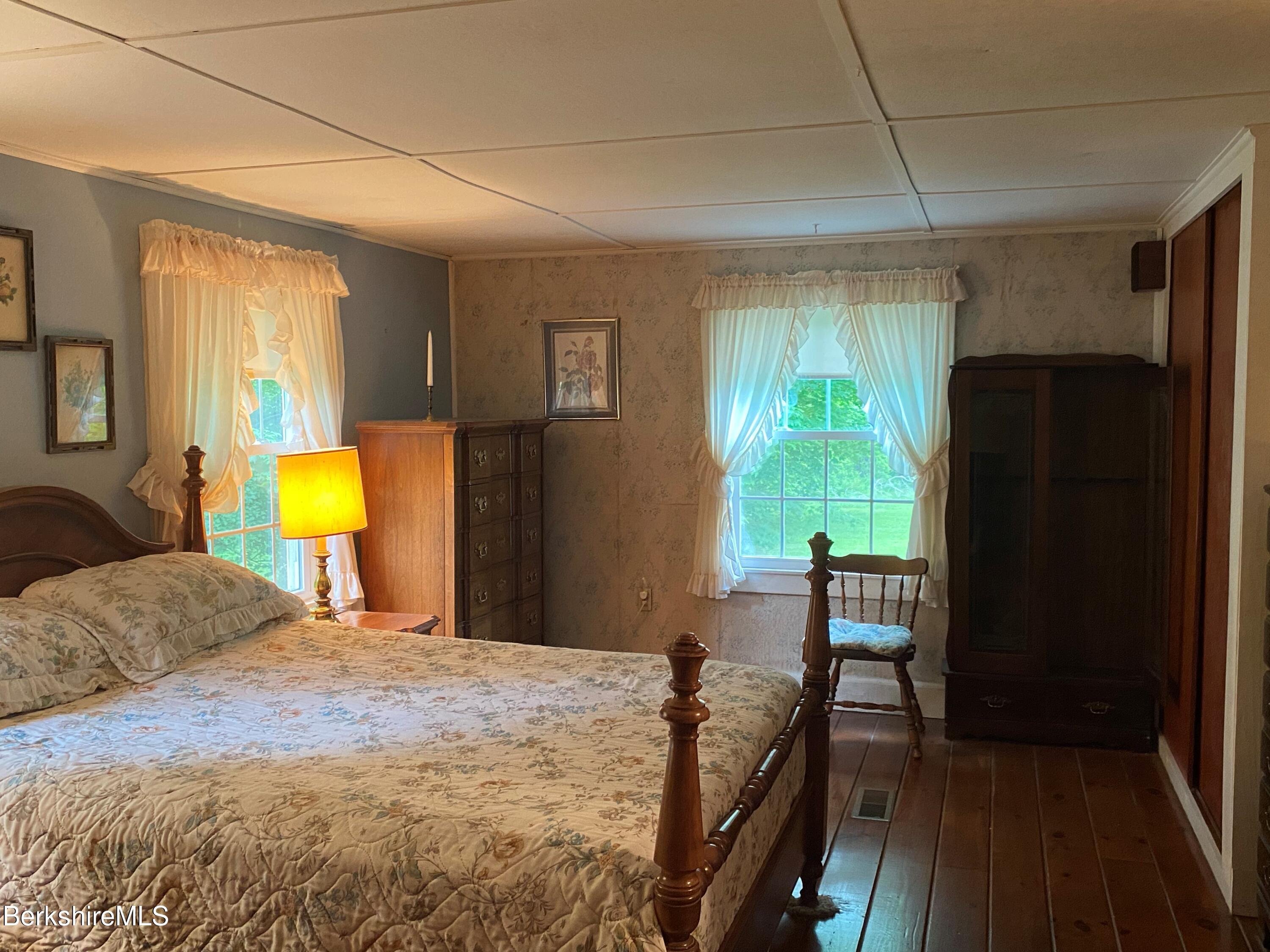 983 State Road Richmond, MA 01254 - Photo 34 of 47 a bedroom with a bed and a dresser next to a window
