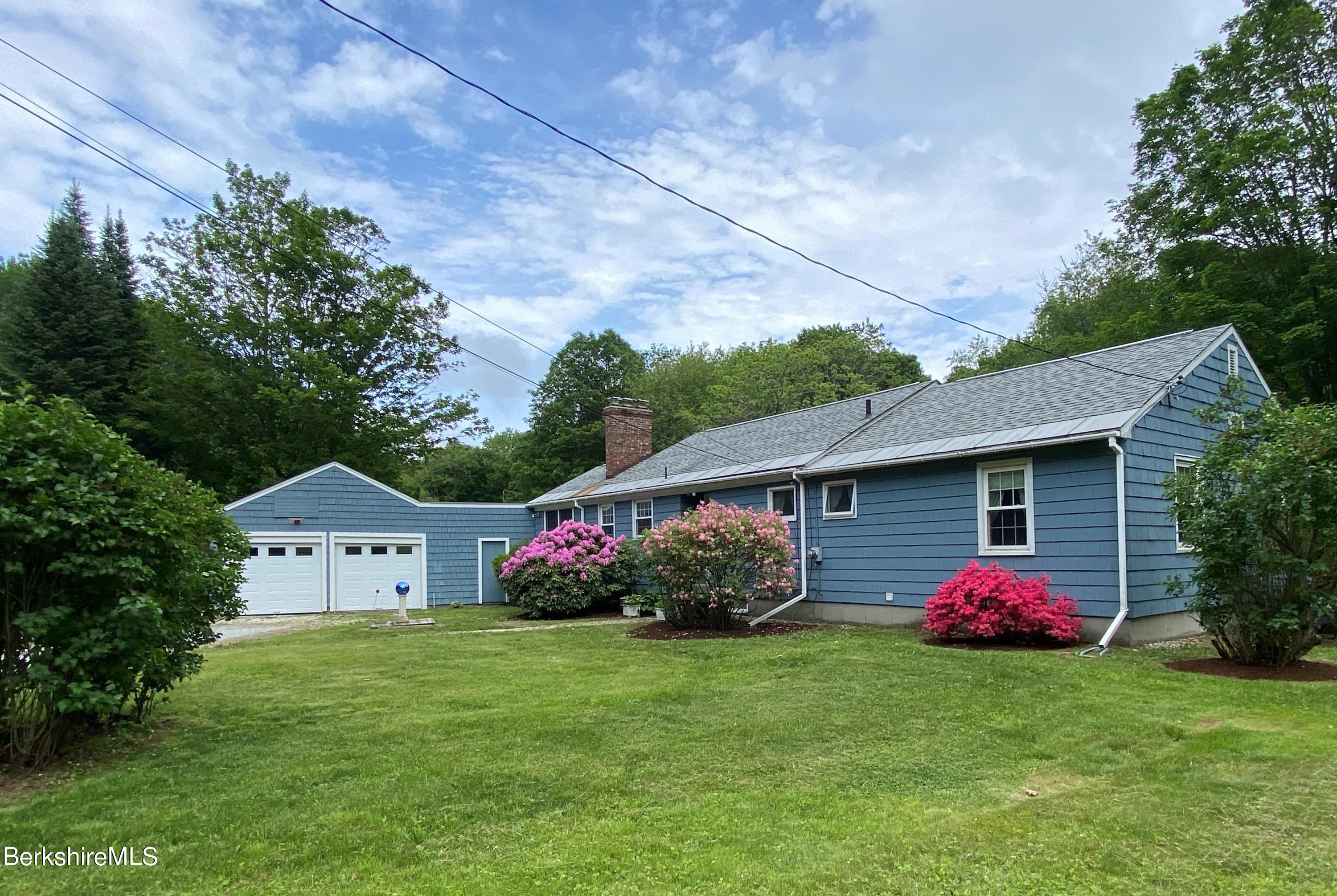 983 State Road Richmond, MA 01254 - Photo 47 of 47 a front view of a house with garden