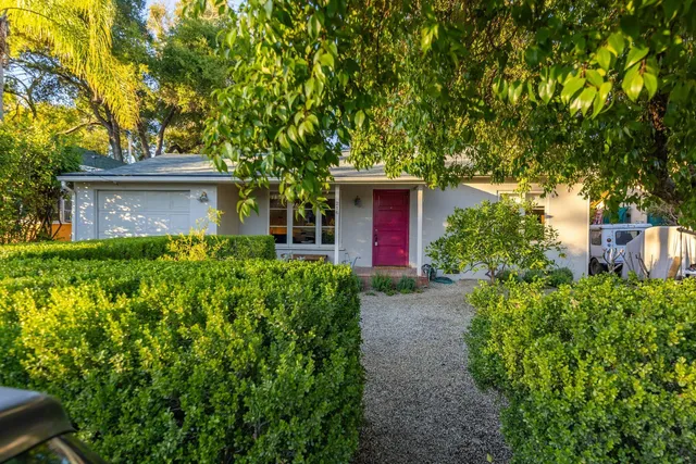 a front view of a house with garden