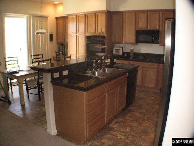 10654 Autumn Walk Lane Reno, NV 89521 - Photo 3 of 7 a kitchen with stainless steel appliances granite countertop a sink stove and cabinets