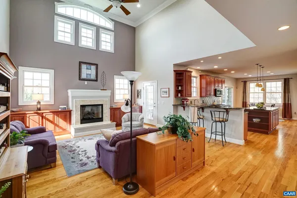 a living room with furniture and view of kitchen