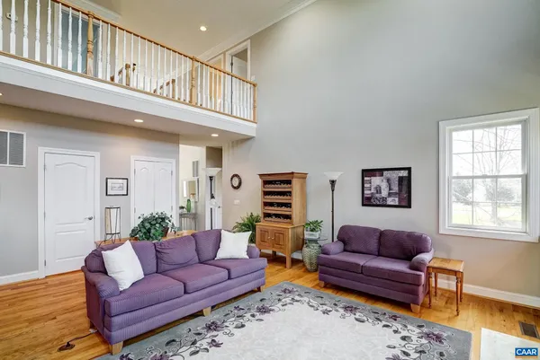 a kitchen with stainless steel appliances granite countertop wooden cabinets a stove a sink and a hard wood floors