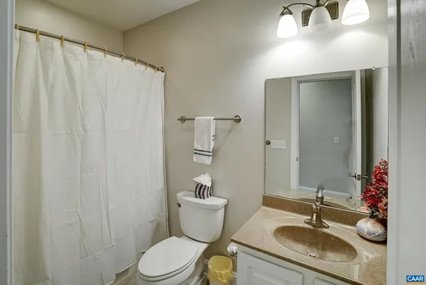 a bathroom with a double vanity sink mirror and toilet