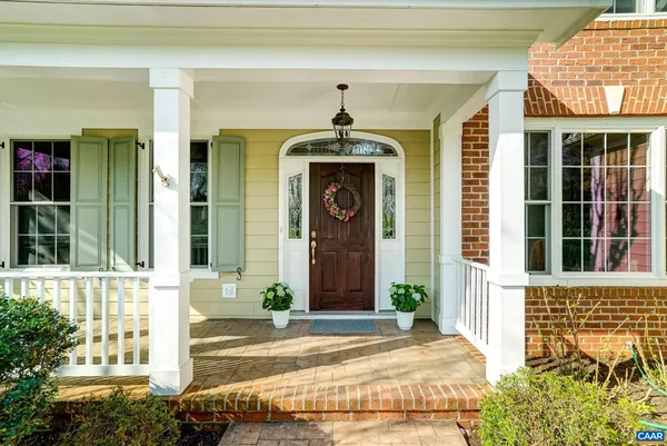 a view of a hallway with wooden floor and stairs