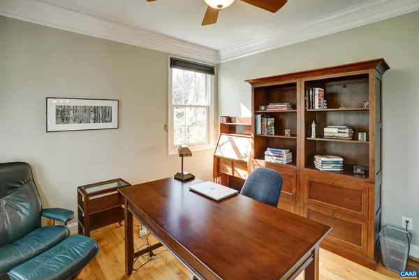 a dining room with furniture a chandelier and wooden floor