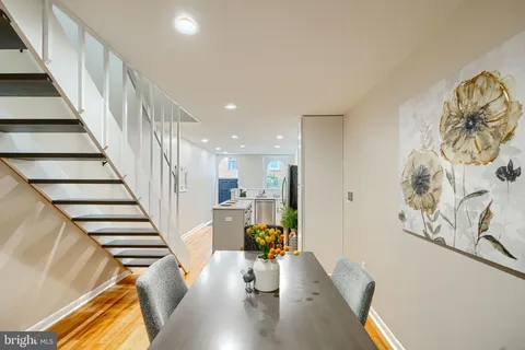 a view of living room with furniture and wooden floor
