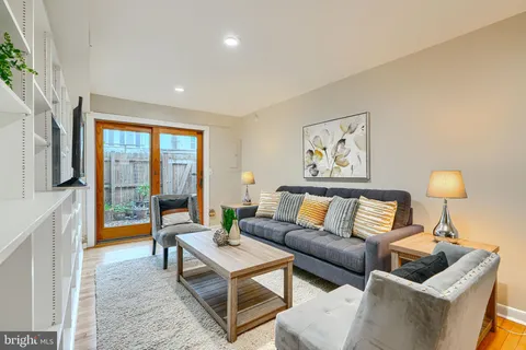 a living room with furniture and a lamp