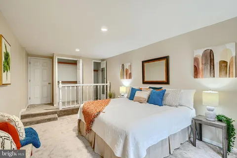 a bedroom with a large bed and a window