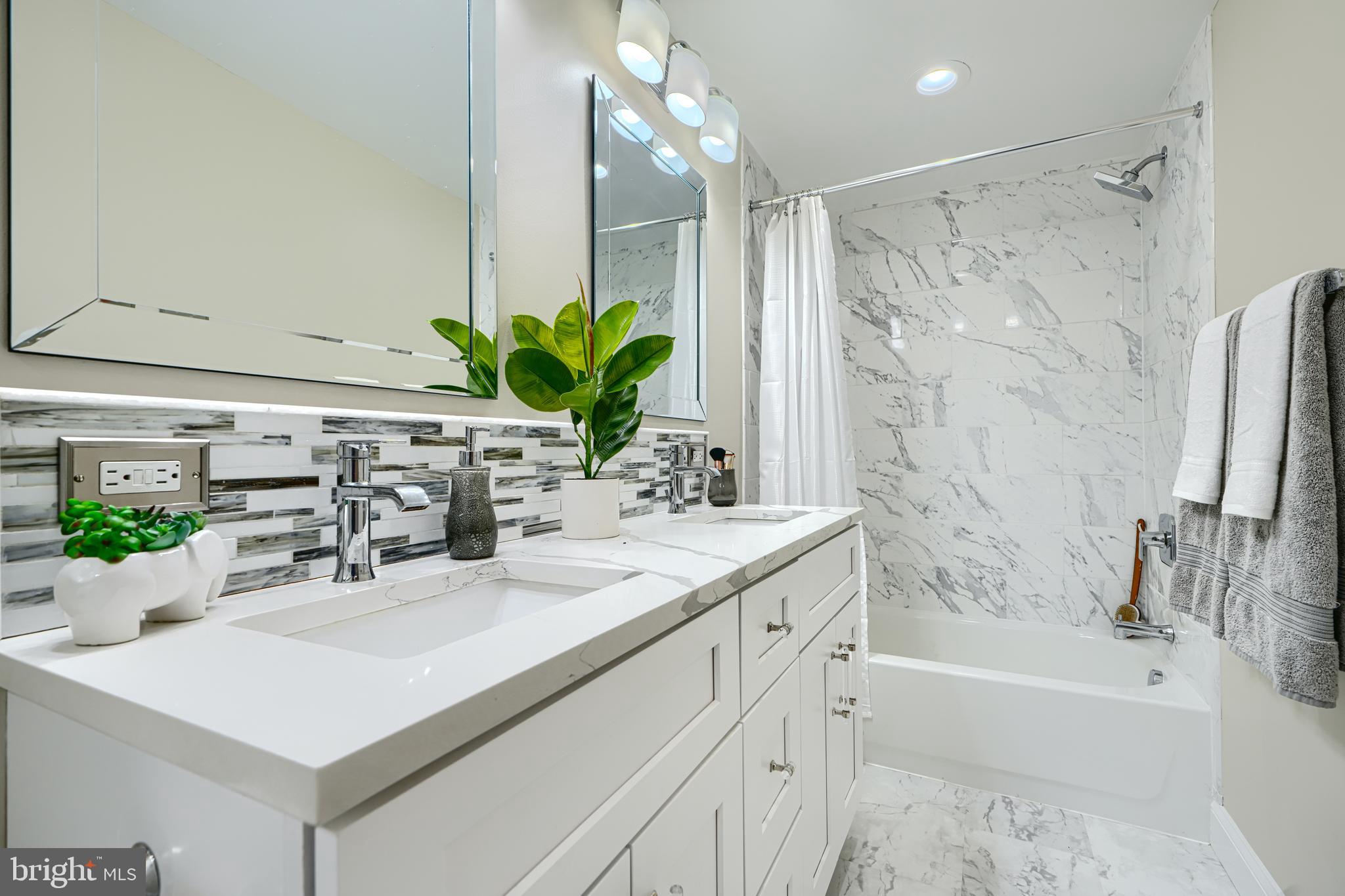 417 Grindall Street Baltimore, MD 21230 - Photo 25 of 37 a bathroom with a sink a large mirror and shower
