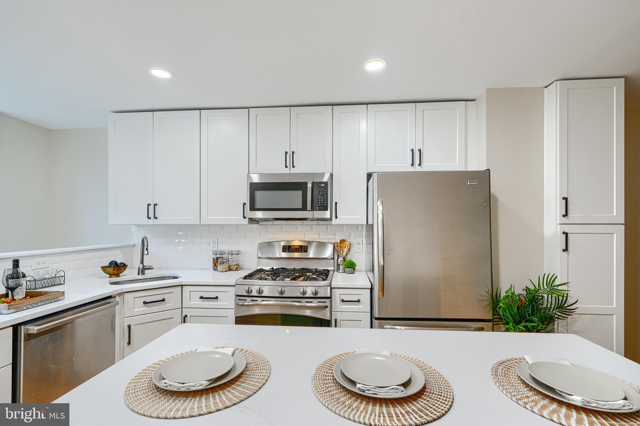 417 Grindall Street Baltimore, MD 21230 - Photo 5 of 37 a kitchen with stainless steel appliances a sink a stove a refrigerator and cabinets