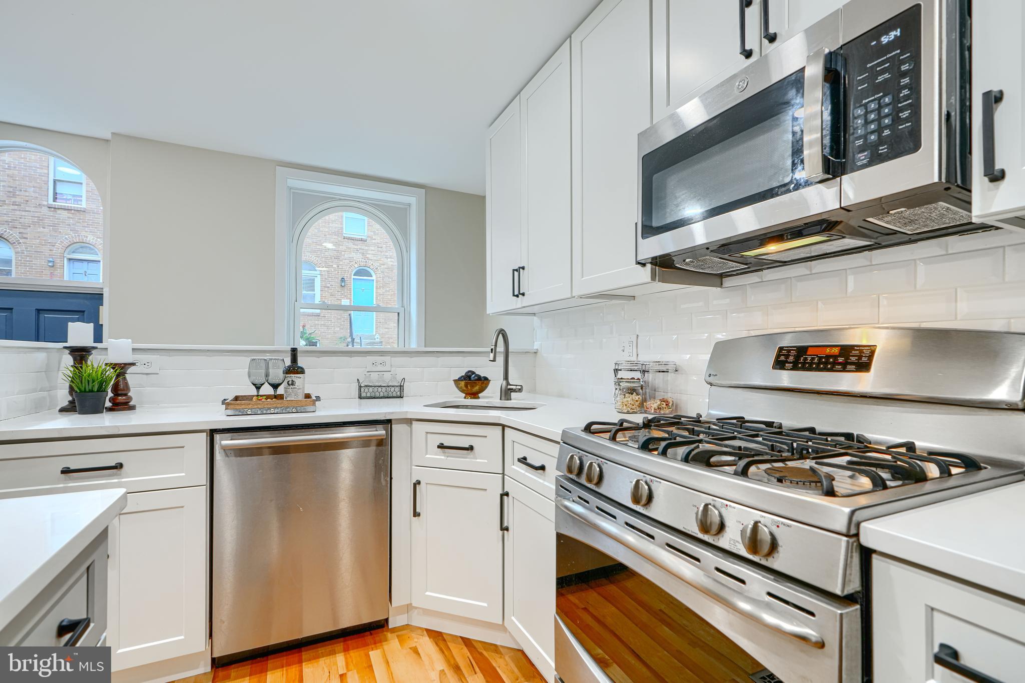 417 Grindall Street Baltimore, MD 21230 - Photo 7 of 37 a kitchen with cabinets appliances and a sink