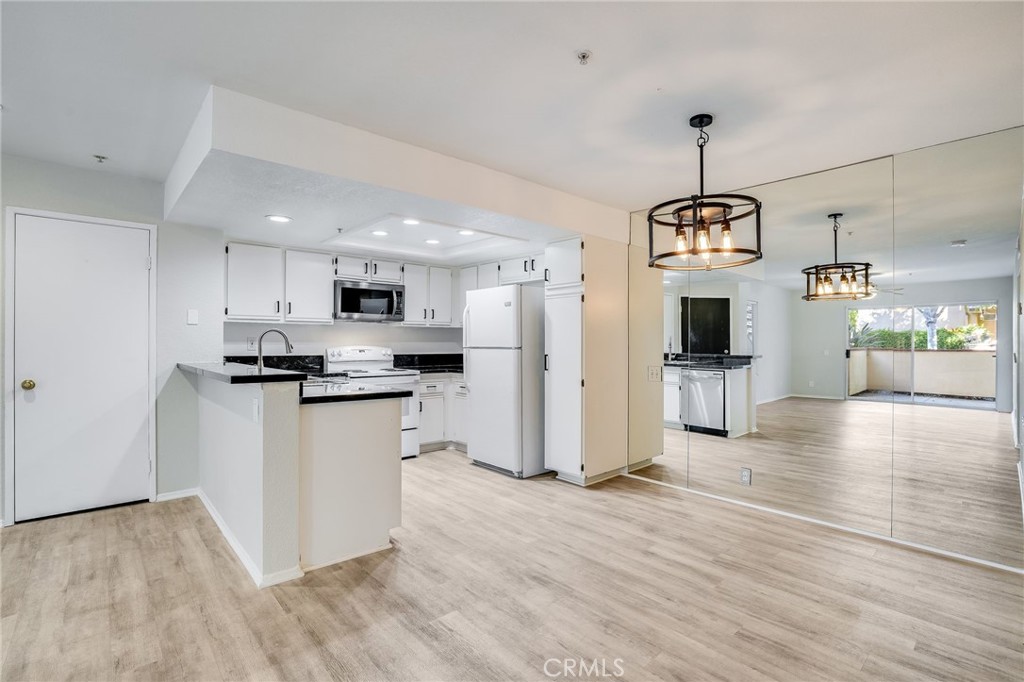158 South Cross Creek Road, Unit B Orange, CA 92869 - Photo 1 of 1 a kitchen with stainless steel appliances kitchen island granite countertop a refrigerator and a stove top oven