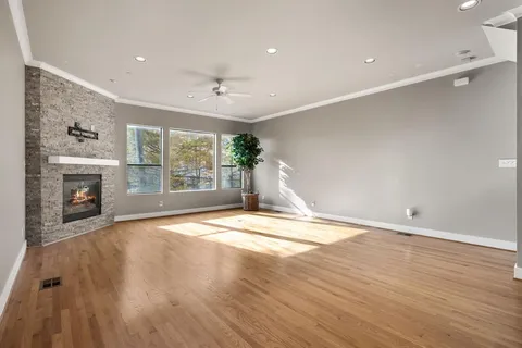 a view of empty room with wooden floor