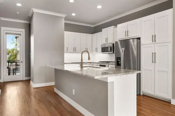 a kitchen with kitchen island a counter top space a sink and cabinets