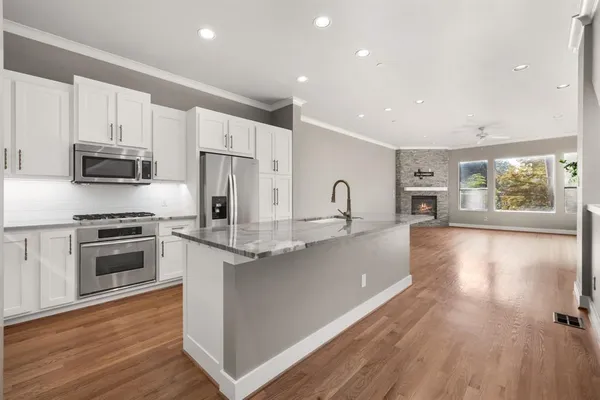 a stove top oven sitting inside of a kitchen