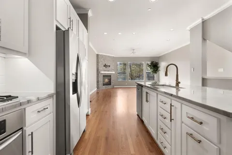 a kitchen with kitchen island a sink stainless steel appliances and cabinets