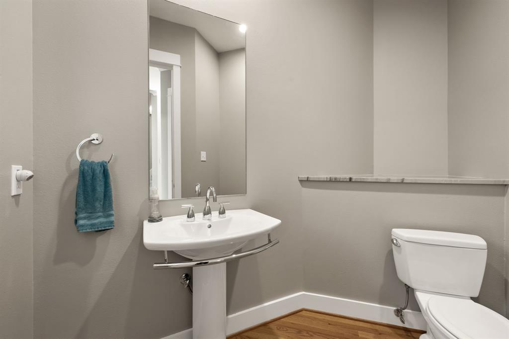 4023 Rawlins Street, Unit 105 Dallas, TX 75219 - Photo 20 of 37 a bathroom with a sink a toilet and mirror