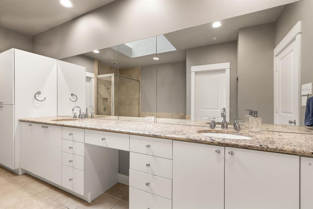 4023 Rawlins Street, Unit 105 Dallas, TX 75219 - Photo 28 of 37 a bathroom with a granite countertop sink double and mirror
