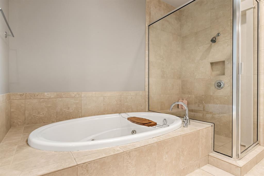 4023 Rawlins Street, Unit 105 Dallas, TX 75219 - Photo 30 of 37 a bathroom with a bathtub and shower