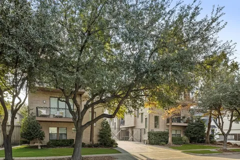 an aerial view of a house with pool and chairs