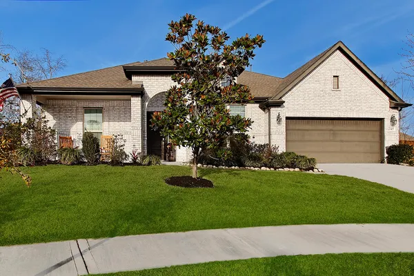 a front view of a house with a garden