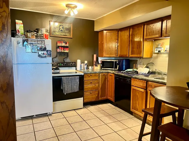 a kitchen with a stove a sink and a refrigerator