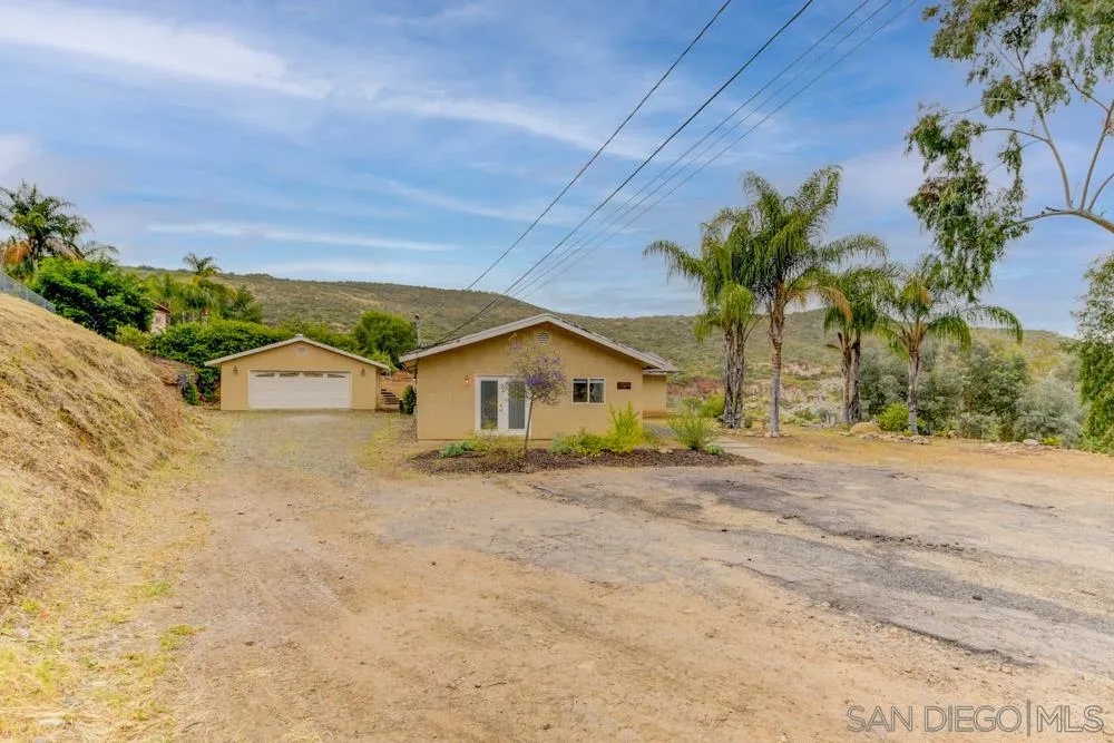 11949 Rocoso Road Lakeside, CA 92040 - Photo 1 of 27 front view of a house with a yard