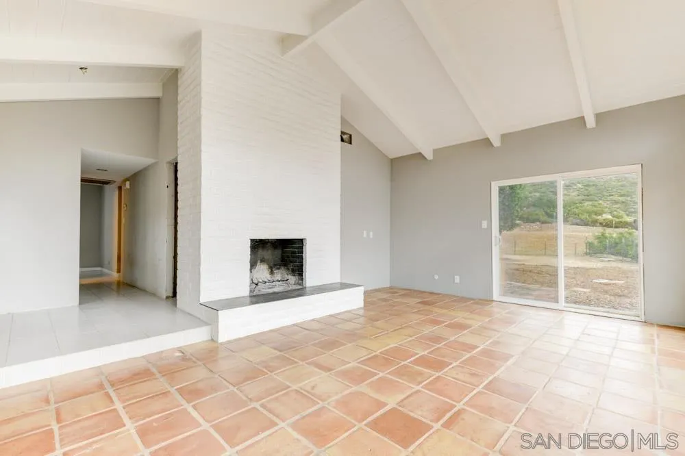 11949 Rocoso Road Lakeside, CA 92040 - Photo 16 of 27 a view of an empty room with a fireplace and a window