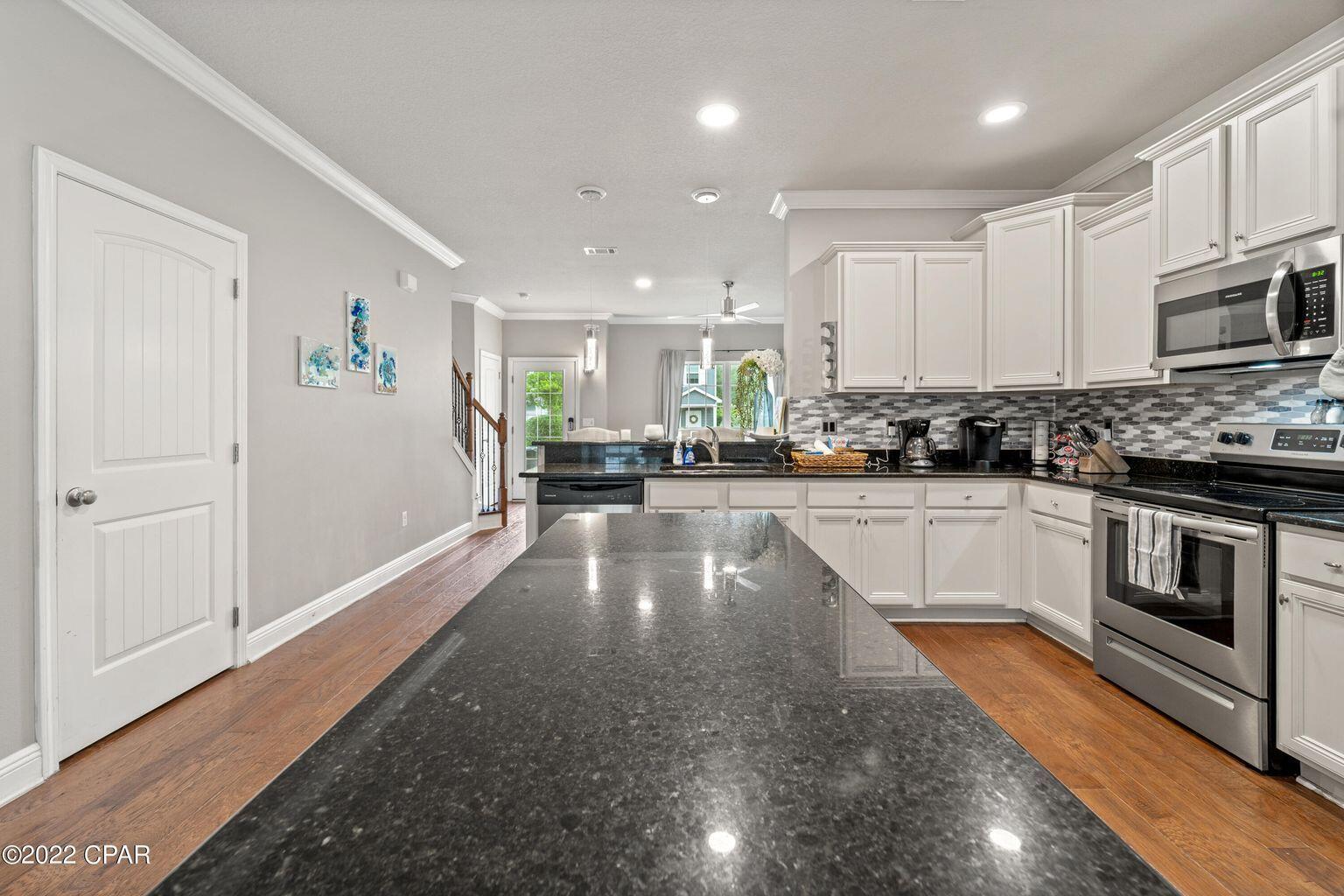 11 Topside Drive Inlet Beach, FL 32461 - Photo 14 of 31 a kitchen with stainless steel appliances granite countertop a stove a sink and white cabinets