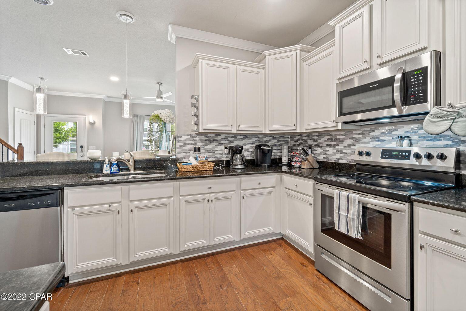 11 Topside Drive Inlet Beach, FL 32461 - Photo 16 of 31 a kitchen with stainless steel appliances granite countertop a stove a sink and a microwave