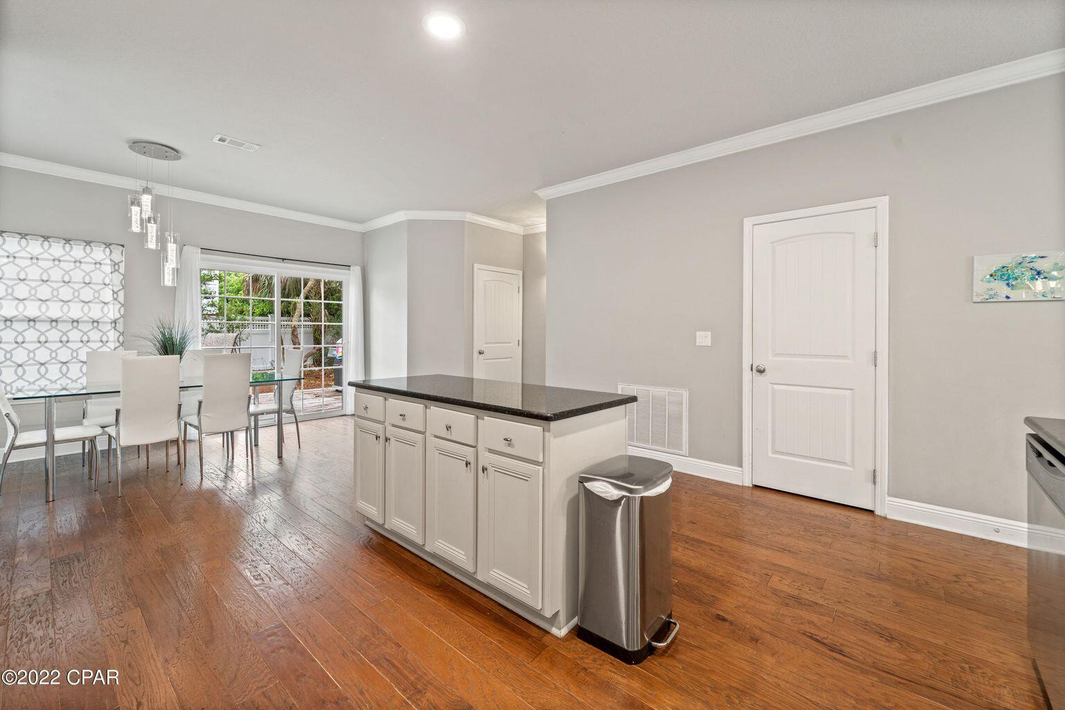 11 Topside Drive Inlet Beach, FL 32461 - Photo 17 of 31 a kitchen with sink cabinets and wooden floor
